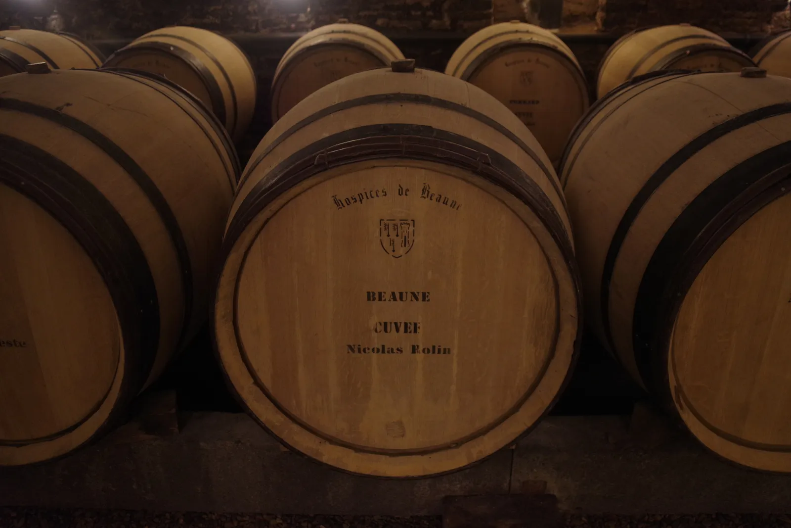 A barrel of the Hospices de Beaune marked “Beaune, Cuvée Nicolas Rolin” among other barrels