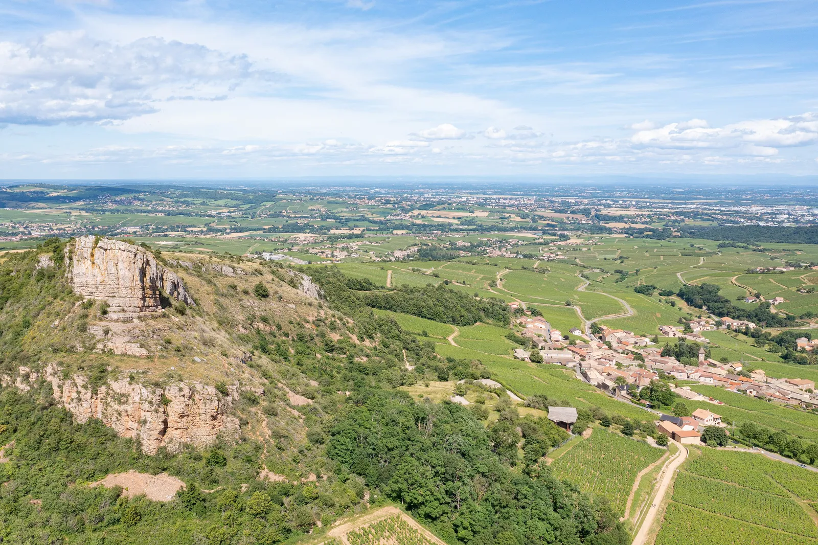 Solutré-Pouilly at the foot of the Rock of Solutré, the Mâconnais vineyards and the Saône plain beyond, from the air